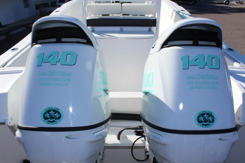 Slide: The Image of 2024 Clearwater 2300 CC boat with dual Suzuki 140 outboard engines. - 20