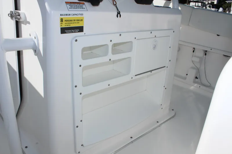 Slide: The Image of 2024 Clearwater 2300 CC boat interior storage compartments and capacity label. - 9