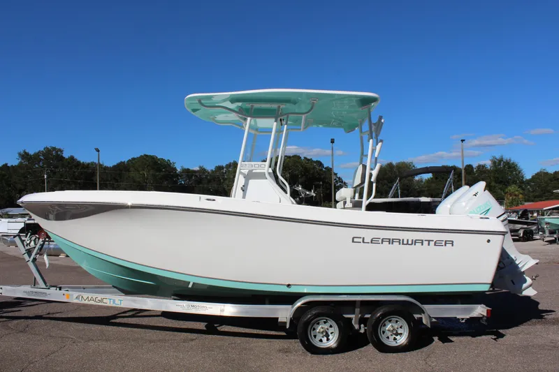 The Image of 2024 Clearwater 2300 CC boat on trailer under clear blue sky. - 1