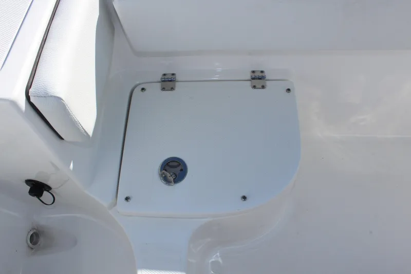 Slide: The Image of 2024 Clearwater 2300 CC boat deck with storage compartment and seating. - 13