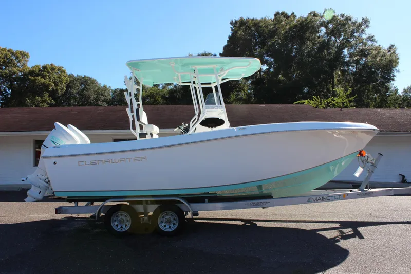 Slide: The Image of 2024 Clearwater 2300 CC boat on trailer, side view, outdoors. - 3