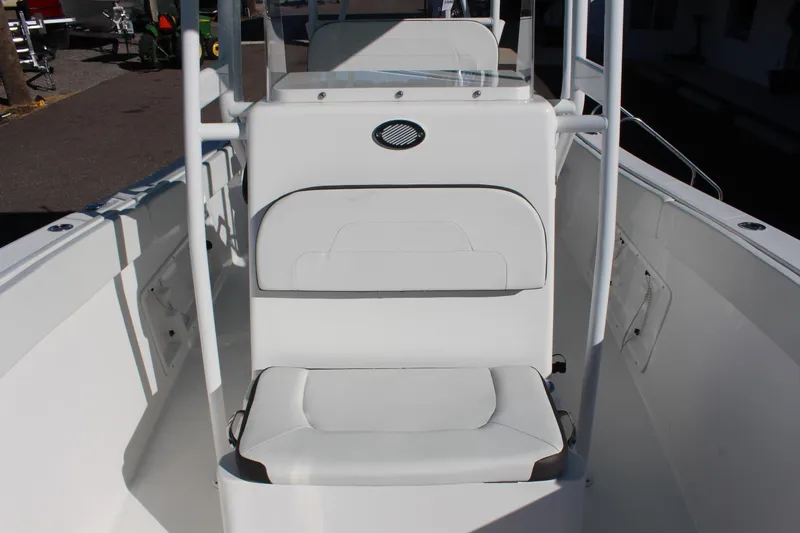 Slide: The Image of 2024 Clearwater 2300 CC boat interior with white seating and console. - 6