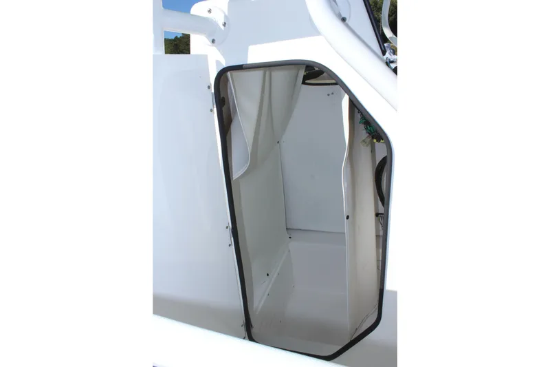 Slide: The Image of 2024 Clearwater 2300 CC boat interior view, showcasing a compact storage compartment. - 7