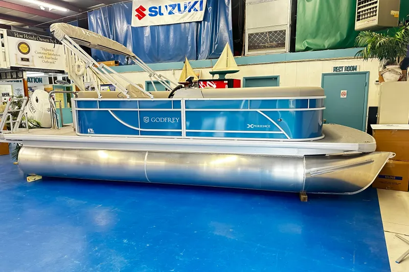 The Image of 2025 Godfrey Experience Cruise 2086CX pontoon boat displayed indoors. - 1