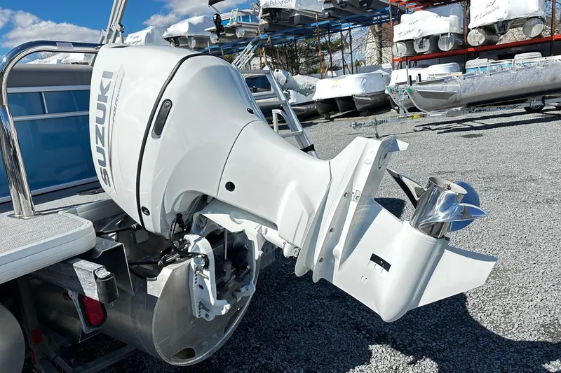Slide: The Image of 2025 Godfrey Experience Cruise 2086CX with Suzuki outboard motor in a boatyard. - 11
