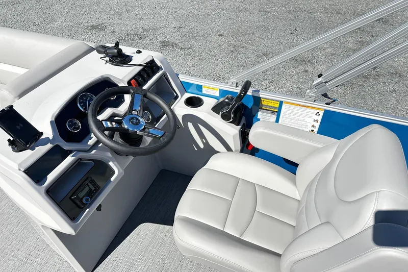 Slide: The Image of 2025 Godfrey Experience Cruise 2086CX boat helm with steering wheel and comfortable seating. - 7