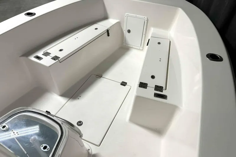 Slide: The Image of 2026 Bay Rider 21 Offshore boat interior with storage compartments and seating. - 11