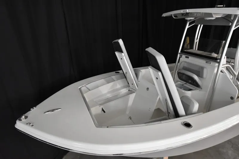 Slide: The Image of 2026 Bay Rider 21 Offshore boat interior with seating and console, showcased indoors. - 12