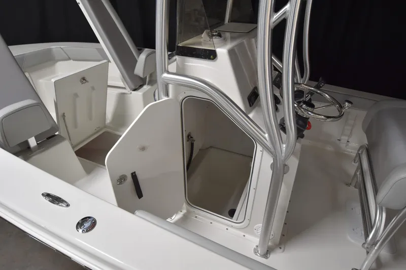 Slide: The Image of 2026 Bay Rider 21 Offshore boat interior with open storage compartments and steering console. - 13