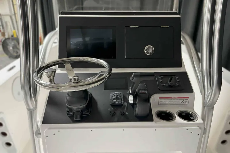 Slide: The Image of Control panel of 2026 Bay Rider 21 Offshore boat with steering wheel and navigation display. - 17