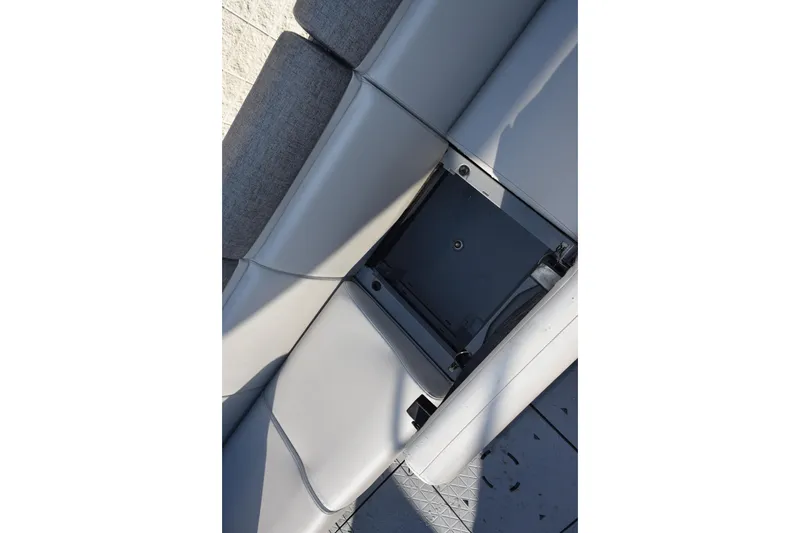Slide: The Image of 2026 Sea-Doo Switch Cruise 21 interior seating with storage compartment open. - 16