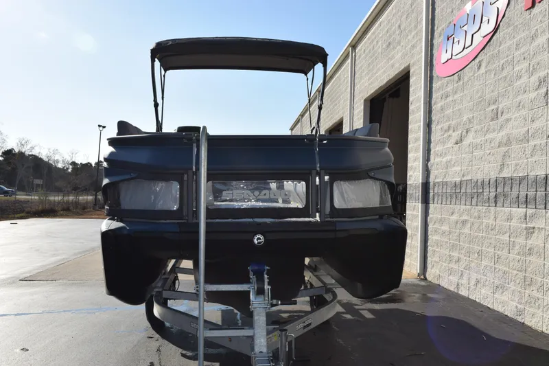 Slide: The Image of 2026 Sea-Doo Switch Cruise 21 on trailer outside dealership building. - 3