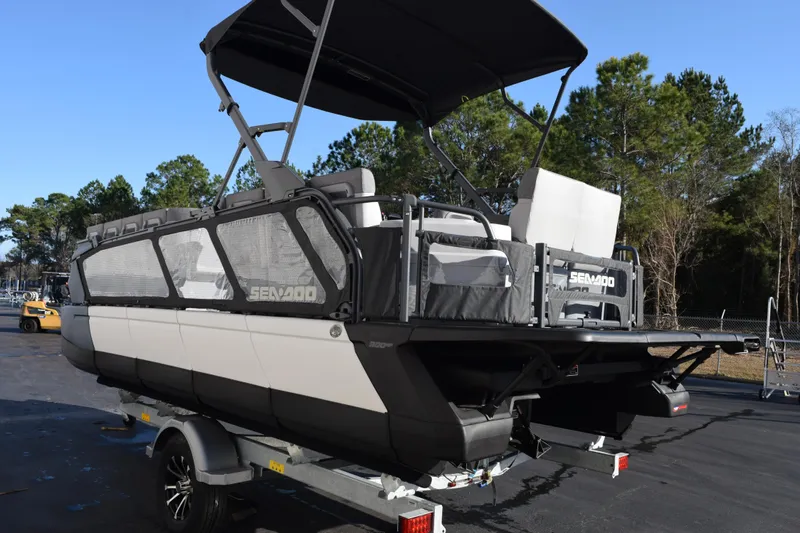 Slide: The Image of 2026 Sea-Doo Switch Cruise 21 pontoon boat on trailer, parked outdoors. - 6