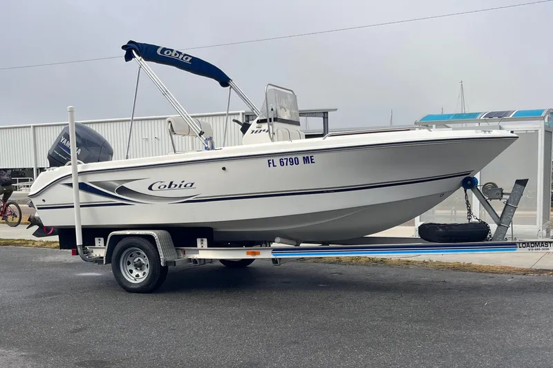 The Image of 2003 Cobia 184 Center Console boat on trailer. - 1