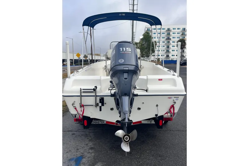 Slide: The Image of 2003 Cobia 184 Center Console boat with Yamaha 115 outboard motor, parked on a trailer. - 10