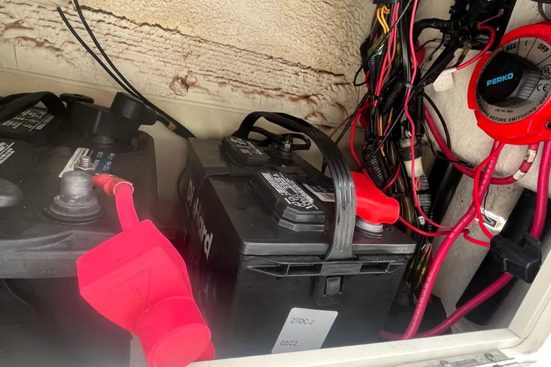 Slide: The Image of Battery compartment of 2003 Cobia 184 Center Console with wiring and Perko switch. - 15