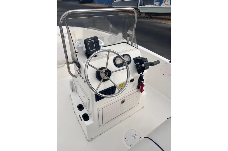 Slide: The Image of 2003 Cobia 184 Center Console boat steering wheel and dashboard. - 17