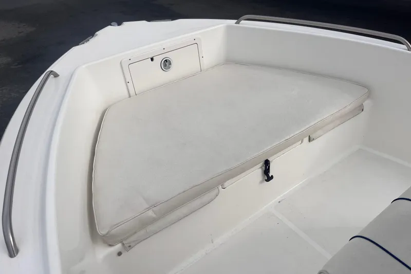 Slide: The Image of 2003 Cobia 184 Center Console boat with cushioned seating and storage compartment. - 19