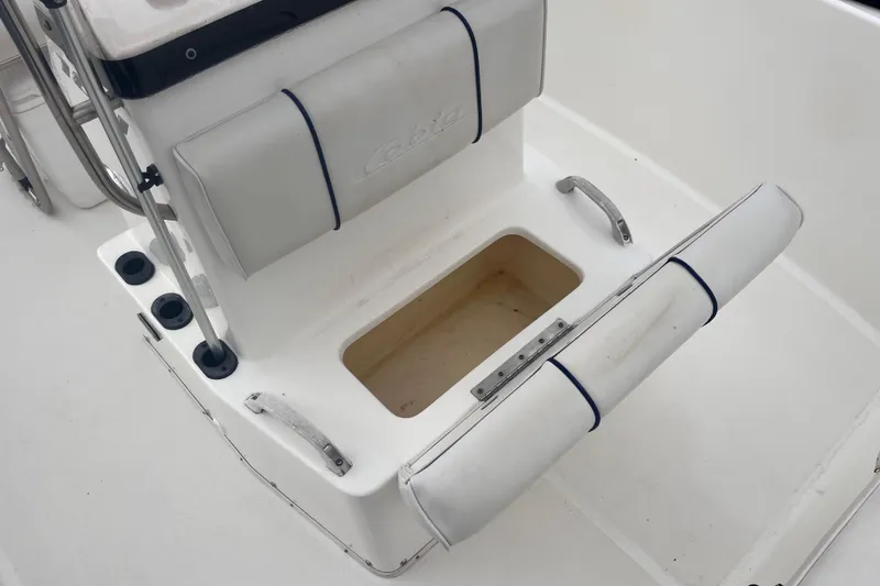 Slide: The Image of 2003 Cobia 184 Center Console boat seat with storage compartment open. - 23