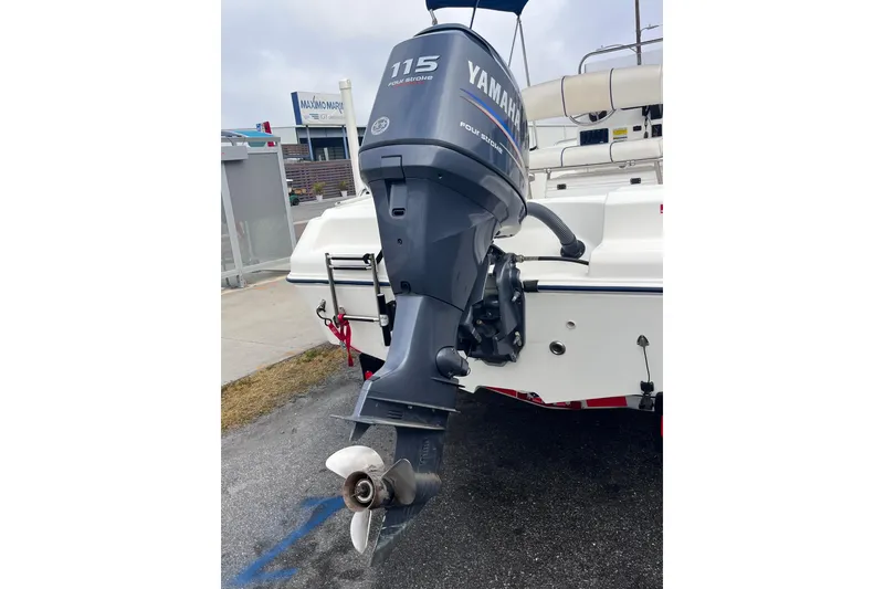 Slide: The Image of 2003 Cobia 184 Center Console with Yamaha 115 outboard motor, docked at marina. - 9