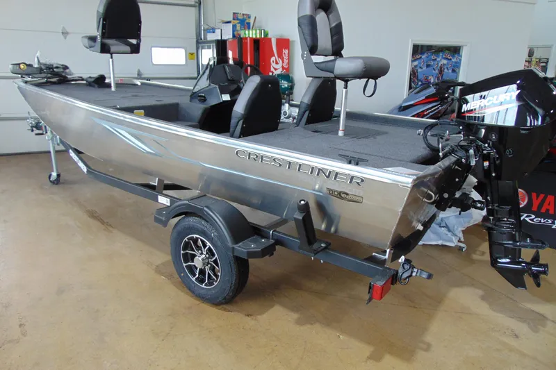 The Image of 2026 Crestliner 1600 Storm boat with Mercury outboard motor on trailer in garage. - 1
