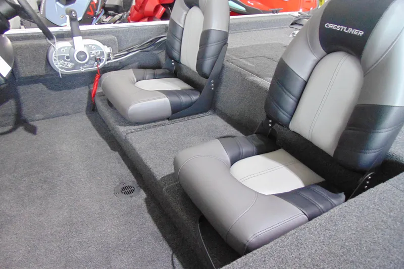 Slide: The Image of 2026 Crestliner 1600 Storm boat interior with dual cushioned seats and steering console. - 11