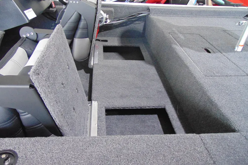 Slide: The Image of 2026 Crestliner 1600 Storm boat interior with open storage compartments and seating. - 12