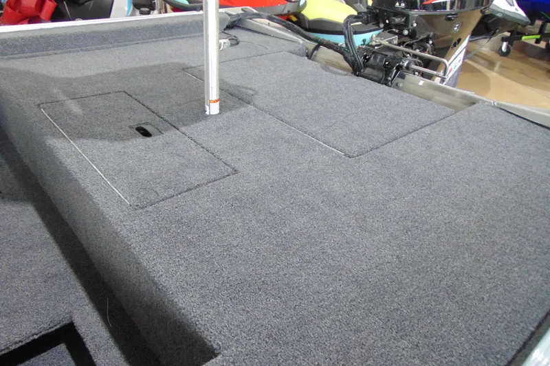 Slide: The Image of 2026 Crestliner 1600 Storm boat deck with carpeted storage compartments. - 13