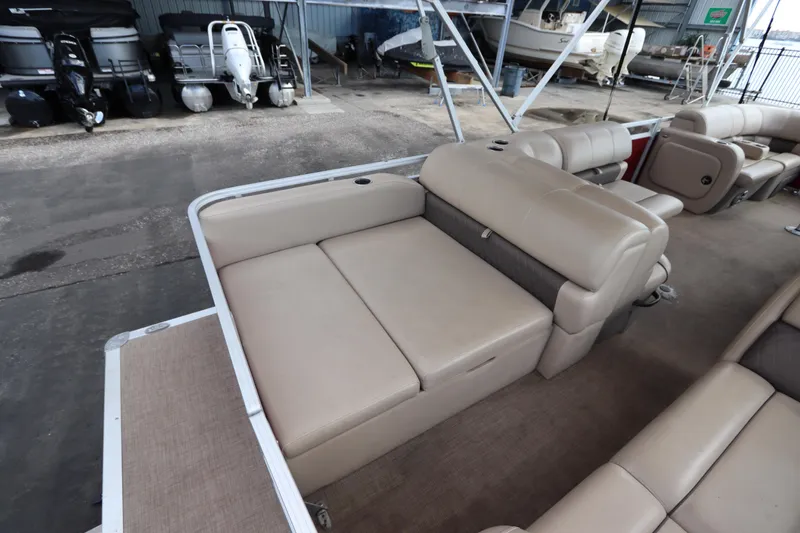 Slide: The Image of 2024 Sun Tracker Party Barge 22 DLX interior seating in a showroom. - 10