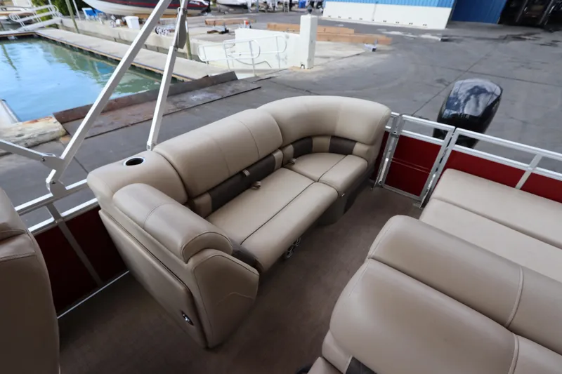 Slide: The Image of 2024 Sun Tracker Party Barge 22 DLX with beige seating, docked near water. - 12