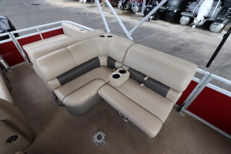 Slide: The Image of 2024 Sun Tracker Party Barge 22 DLX interior seating with cup holders, beige upholstery. - 14