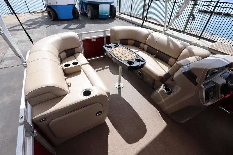 Slide: The Image of 2024 Sun Tracker Party Barge 22 DLX interior with plush seating and table. - 15