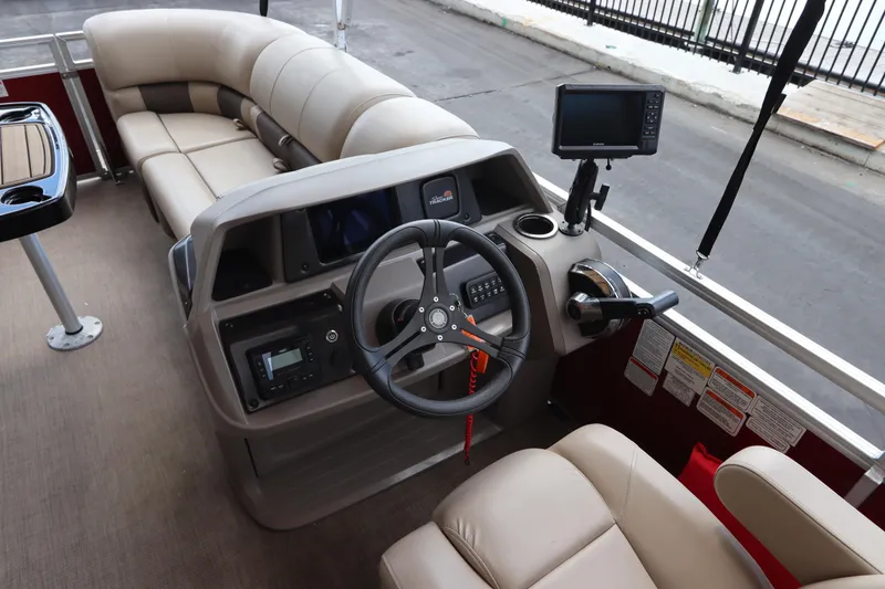 Slide: The Image of 2024 Sun Tracker Party Barge 22 DLX interior with steering console and seating. - 17