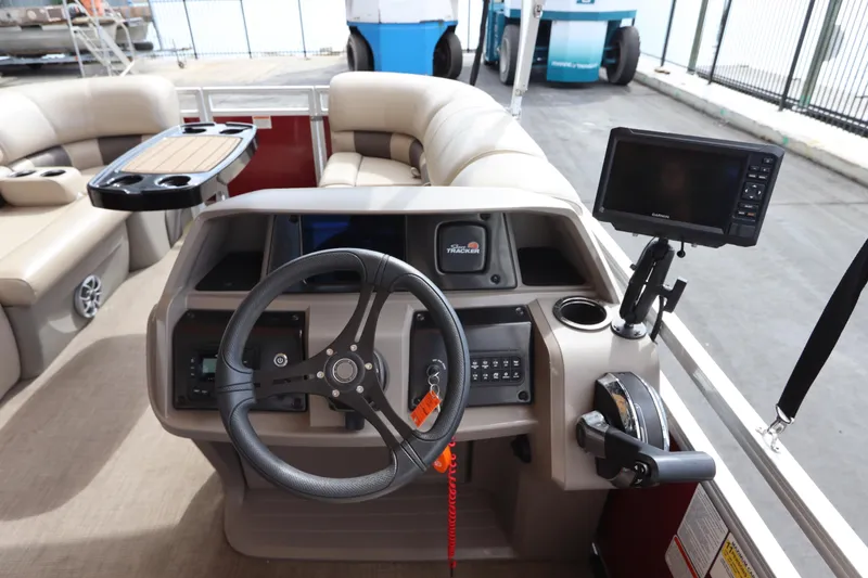 Slide: The Image of 2024 Sun Tracker Party Barge 22 DLX helm with steering wheel and navigation system. - 18