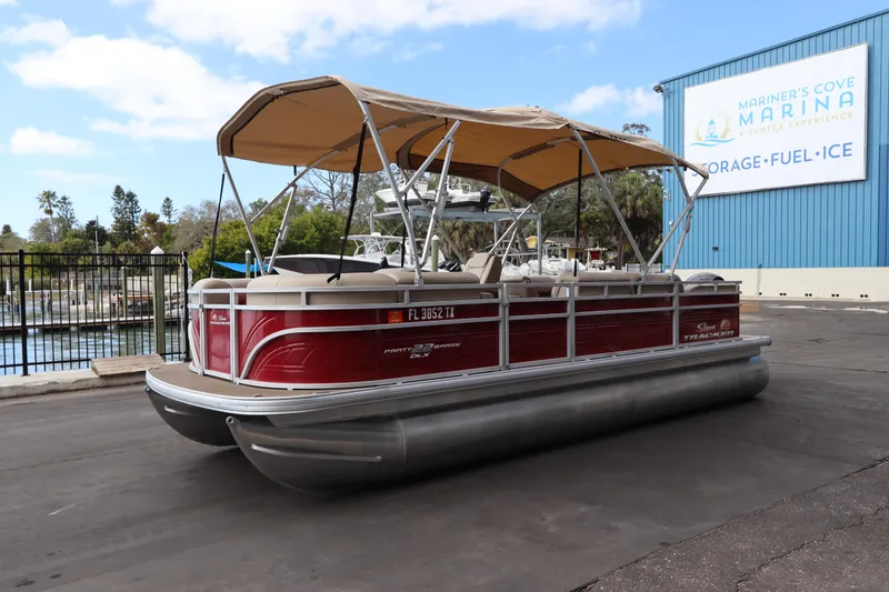 Slide: The Image of 2024 Sun Tracker Party Barge 22 DLX pontoon boat at marina with canopy. - 3