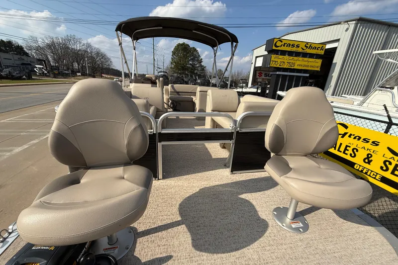 Slide: The Image of 2019 Avalon Venture 1880 CRB pontoon boat with beige seating, displayed outdoors. - 10