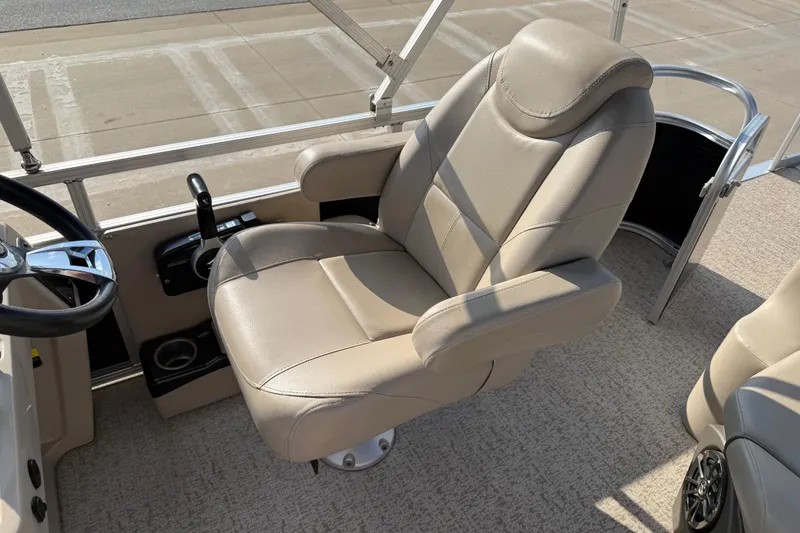 Slide: The Image of 2019 Avalon Venture 1880 CRB boat interior with beige captain's chair and steering wheel. - 17