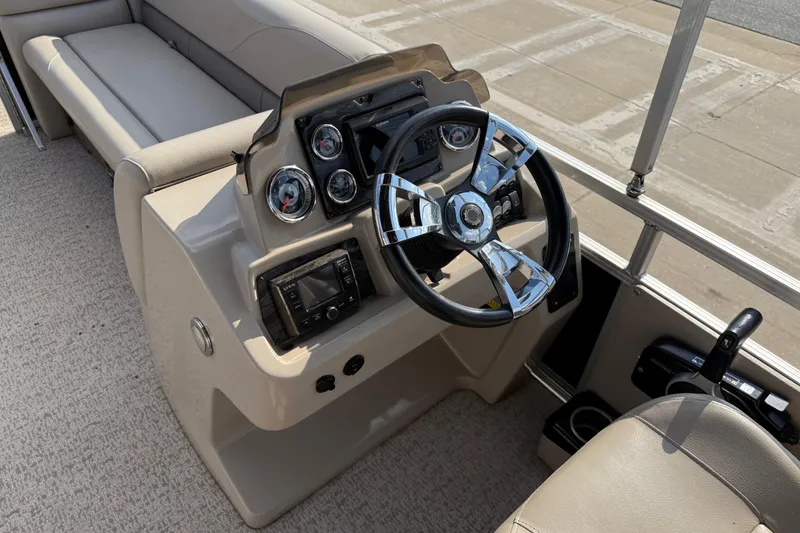 Slide: The Image of 2019 Avalon Venture 1880 CRB boat dashboard with steering wheel and controls. - 18