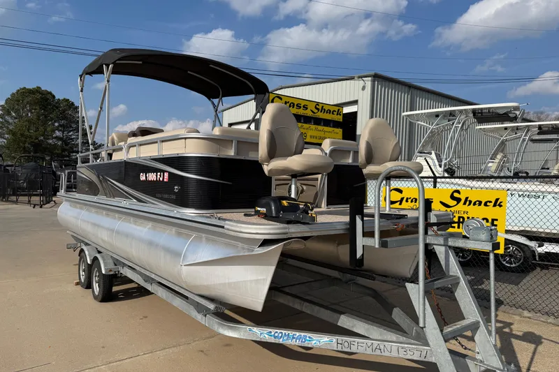 Slide: The Image of 2019 Avalon Venture 1880 CRB pontoon boat on trailer, parked outside dealership. - 2