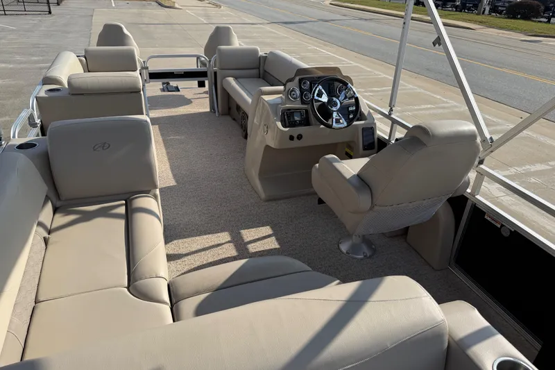 Slide: The Image of 2019 Avalon Venture 1880 CRB pontoon boat interior with beige seating and steering console. - 26