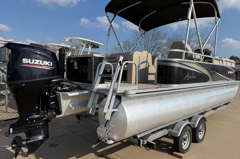 Slide: The Image of 2019 Avalon Venture 1880 CRB pontoon boat with Suzuki outboard motor on trailer. - 7