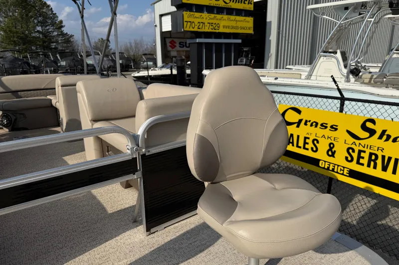 Slide: The Image of 2019 Avalon Venture 1880 CRB boat interior with beige seating at a sales lot. - 9