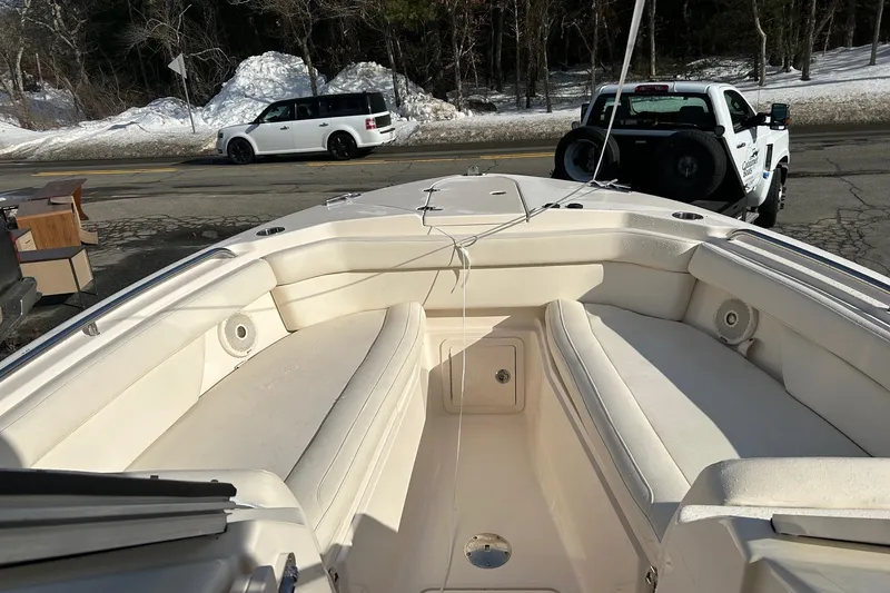 Slide: The Image of 2017 Grady-White Freedom 285 boat interior with seating, parked near snowy road. - 3