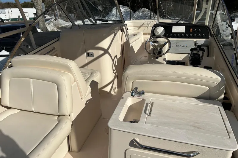 Slide: The Image of 2017 Grady-White Freedom 285 boat interior with steering wheel and seating. - 5