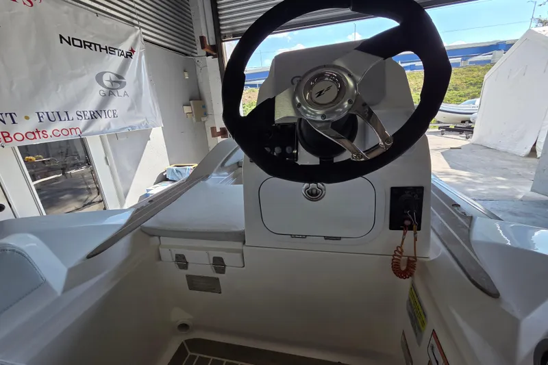 Slide: The Image of 2023 Zar ZF-0 boat interior with steering wheel, Suzuki 40HP engine, in showroom. - 4
