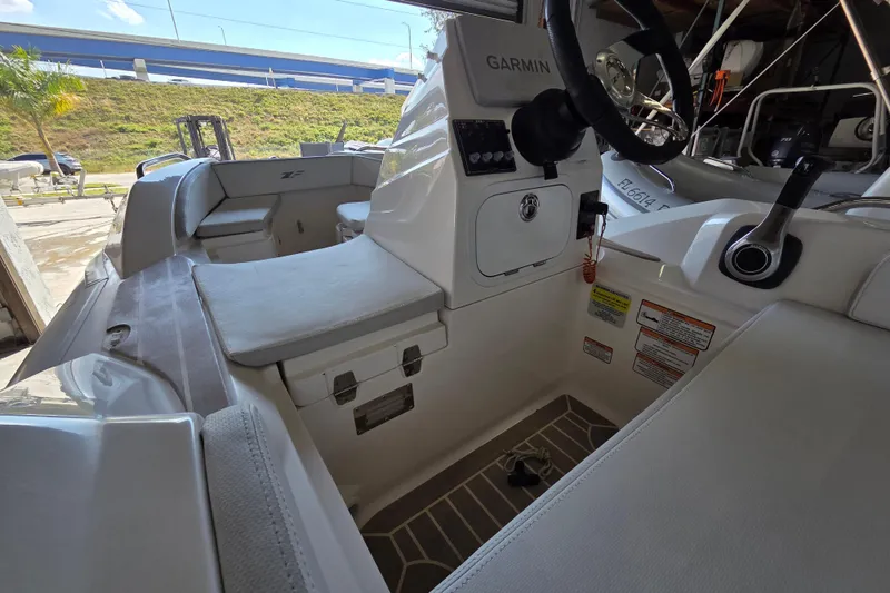 Slide: The Image of 2023 Zar ZF-0 boat interior with Suzuki 40HP engine, featuring Garmin navigation system. - 6