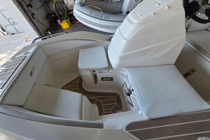 Slide: The Image of 2023 Zar ZF-0 boat interior with Suzuki 40HP engine, featuring white seating and storage. - 9