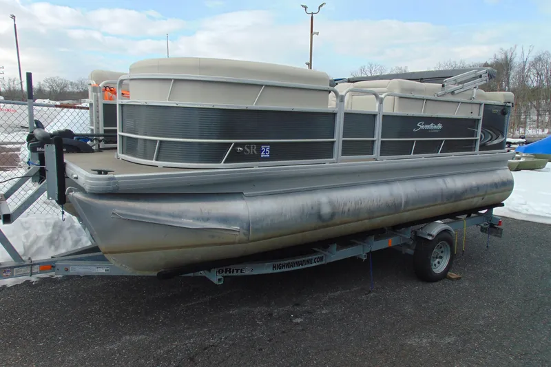 The Image of 2019 Godfrey SW 180C pontoon boat on trailer, parked outdoors. - 1
