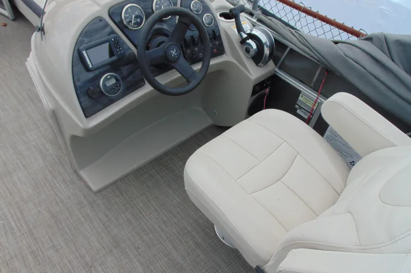 Slide: The Image of 2019 Godfrey SW 180C boat dashboard with steering wheel and beige captain's chair. - 12