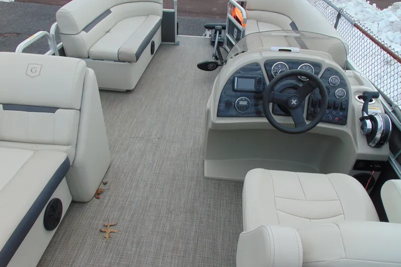 Slide: The Image of 2019 Godfrey SW 180C pontoon boat interior with beige seating and control panel. - 15